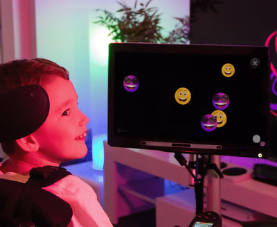 Boy with a disability using Sensory Eye FX 2 to practice eye tracking skills